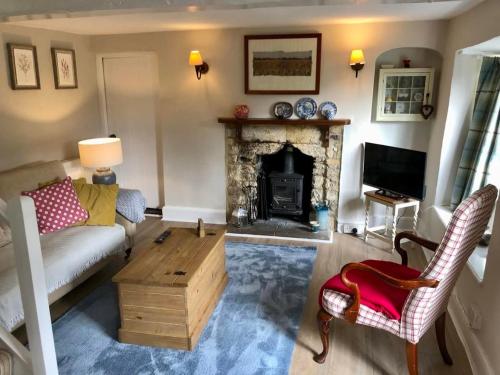 a living room with a couch and a fireplace at Amberley Inn in Stroud