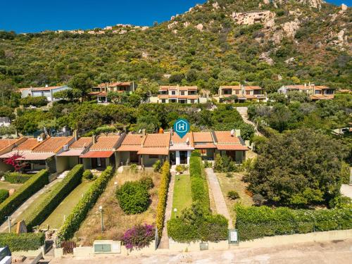 an aerial view of a house with a mountain at Casa Vacanze Claudia in Costa Rei