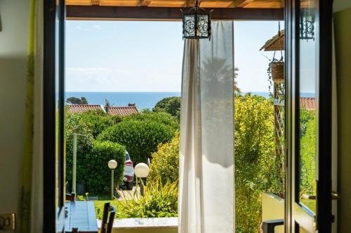 a view of the ocean from a window at Casa Vacanze Claudia in Costa Rei