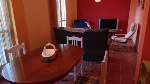 a dining room with a wooden table and chairs at Luz de Ardales in Ardales