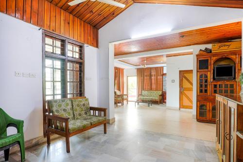 a living room with a couch and a tv at Exotic Villa Homestay in Guwahati