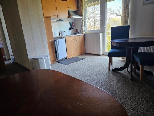 a kitchen with a table and a dining room table at Ferienwohnung Seegat Nr 1 in Norden