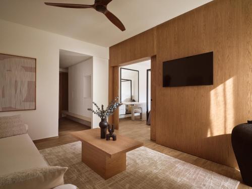 a living room with a couch and a tv on a wall at Lesante Classic - Preferred Hotels & Resorts in Tsilivi