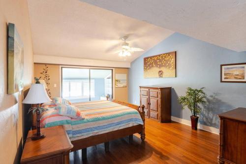 a bedroom with a bed and a large window at Canterbury Oasis in Haines City