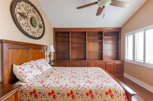 a bedroom with a bed and a clock on the wall at Canterbury Oasis in Haines City
