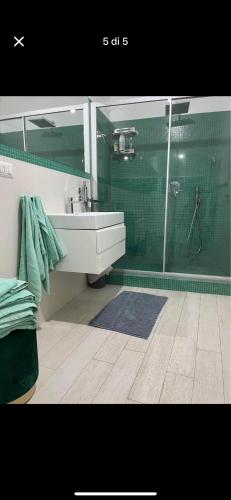 a bathroom with a sink and a glass shower at Luxro Home Crotone in Crotone