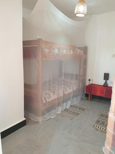 a room with two bunk beds in a room at Alison & Dave's Guesthouse in Entebbe