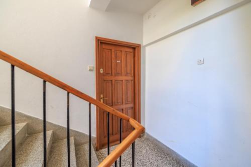 a staircase with a wooden door in a building at Durasin in Crikvenica