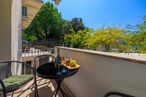 a table with a plate of food on a balcony at Durasin in Crikvenica