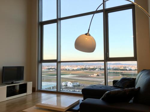 a living room with a large window and a couch at Panoramic Suites II By VALENCIAFLATS EU in Valencia