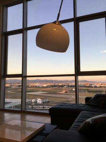 a living room with a large window looking out at an airport at Panoramic Suites II By VALENCIAFLATS EU in Valencia