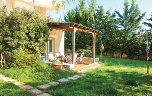 a gazebo with a table and chairs in a yard at Schinias Forest Beach House in Marathón