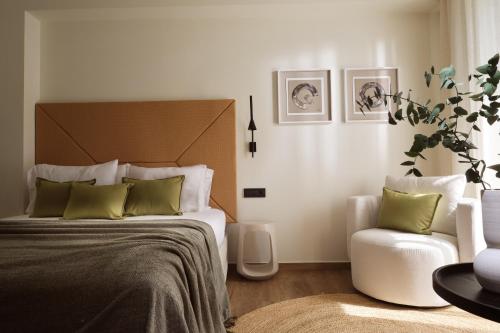 a bedroom with a large bed and a chair at Lesante Classic - Preferred Hotels & Resorts in Tsilivi