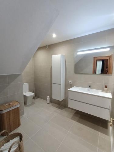a bathroom with a sink and a toilet at Townhouse da Amarela in Budens