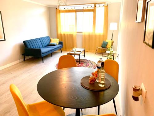 a living room with a table and chairs at Sunny Stay in El Médano