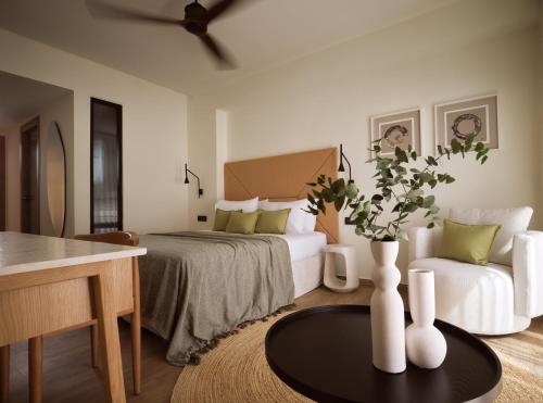 a bedroom with a bed and a couch and a table at Lesante Classic - Preferred Hotels & Resorts in Tsilivi