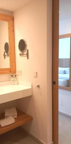 a bathroom with a sink and a mirror at Hotel Bahia Pollensa in Port de Pollensa
