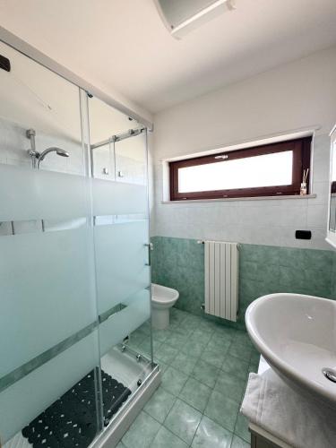 a bathroom with a glass shower and a sink at HomeAway Pescara Airport in San Giovanni Teatino