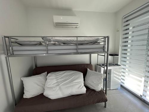 - une chambre avec des lits superposés et des oreillers blancs dans l'établissement Appartement bord de mer, à La Ciotat