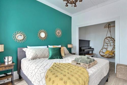 a bedroom with a large bed and a blue wall at 2BR - Hot Tub & 2 Parking - 8 min to Old Quebec in Quebec City