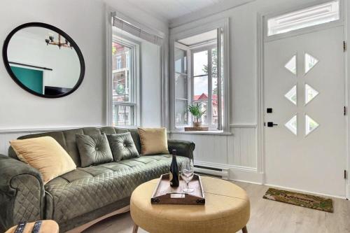 a living room with a couch and a table at 2BR - Hot Tub & 2 Parking - 8 min to Old Quebec in Quebec City