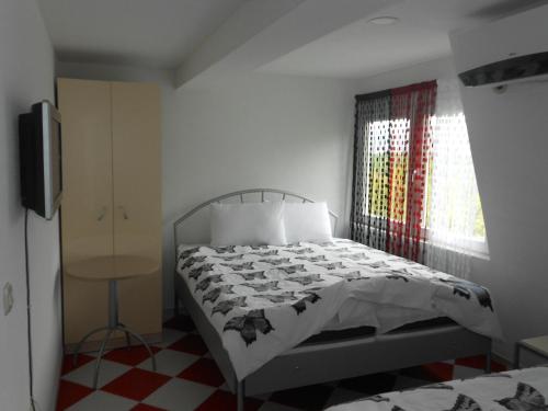 a bedroom with a bed and a window at Villa Angel Apartments - OHRID- in Ohrid