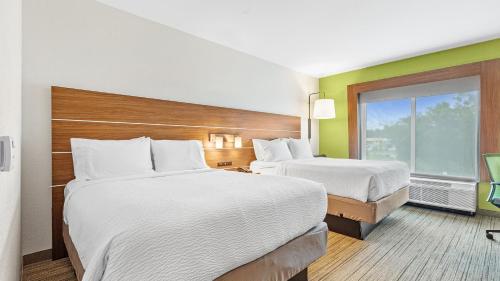 a hotel room with two beds and a window at Holiday Inn Express & Suites Mobile - University Area by IHG in Mobile