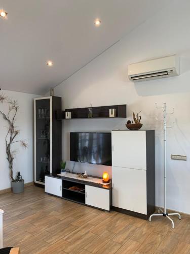 a living room with a large white entertainment center at Apartamento 2 habitaciones ZEN in Deltebre