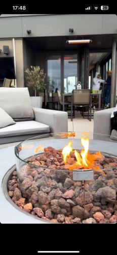 a large fire pit with a bunch of meat and flames at Best Penthouse in London in London