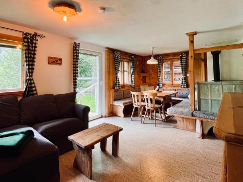 a living room with a couch and a table at Schmirnhaus in Schmirn