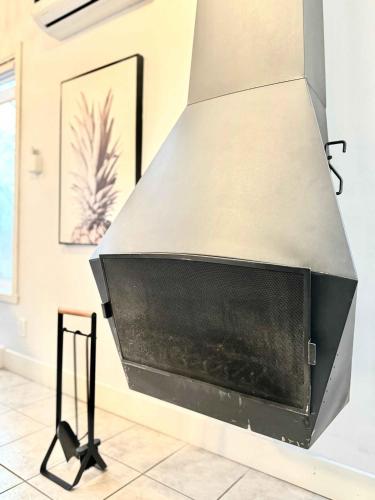 a metal hood over a fireplace in a room at HAPPY HOUR - Condo Water Park in Beaupré