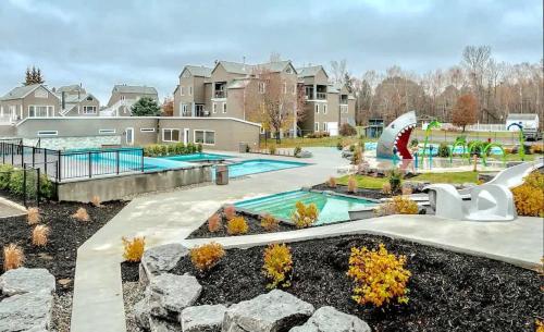 a backyard with a pool and a water park at HAPPY HOUR - Condo Water Park in Beaupré