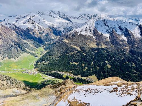 an aerial view of a mountain range with snow covered mountains at Schmirnhaus in Schmirn