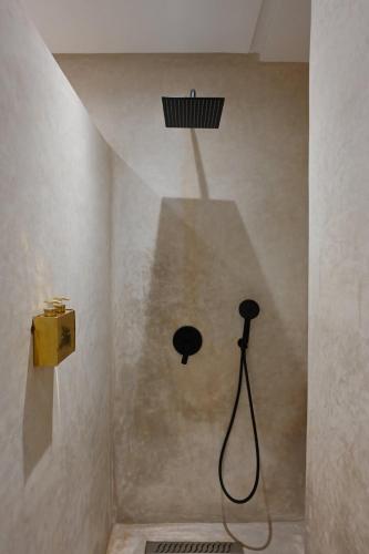 a shower with a shower head in a bathroom at Suite Ivoire - Elegance a Gueliz in Marrakech