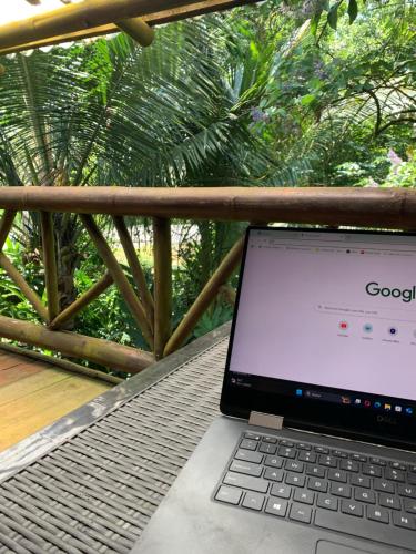 a laptop computer sitting on a table on a balcony at El Mono de Pacoche in Manta