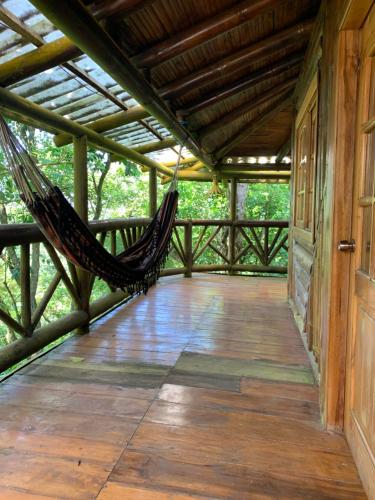 a hammock on the porch of a house at El Mono de Pacoche in Manta