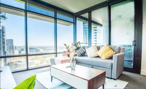 a living room with a couch and a coffee table at Sky-High Luxury Retreat with Breathtaking View in Sydney