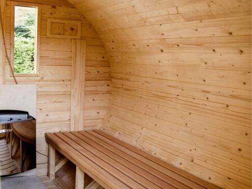 a wooden sauna with a bench in the corner at Diuna Beskidy Ustroń - dawny Kolejarz in Ustroń