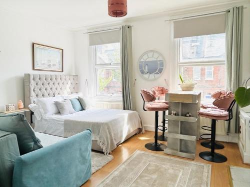 a living room with a bed and a couch at Apollo Hammersmith Studio in London