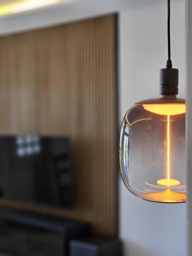 a glass light bulb hanging from a ceiling at Palacio Suites Marbella in Marbella