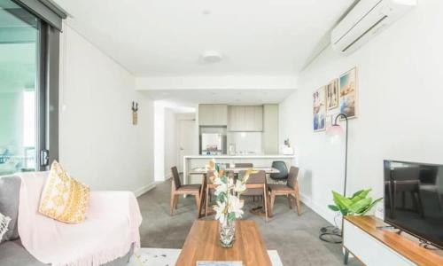 a living room with a couch and a table at Sky-High Luxury Retreat with Breathtaking View in Sydney