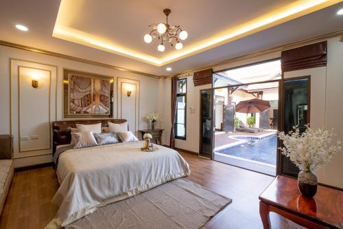 a bedroom with a bed and a pool at Modern Lanna Style Grand Pool Villa in Chiang Mai