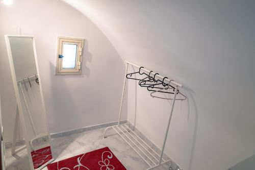 a white room with a mirror and a red rug at Caravigna Love in Carovigno