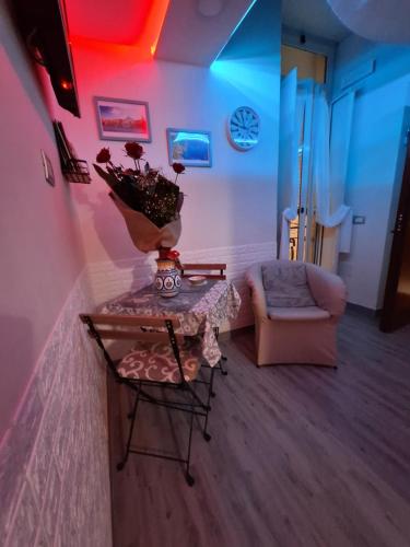 a living room with a table and a couch at LA CASA DI NANA' in Naples