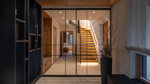 a house with a glass door leading to a staircase at steiRerBLiCke - Domaine Sernau Muscat in Gamlitz