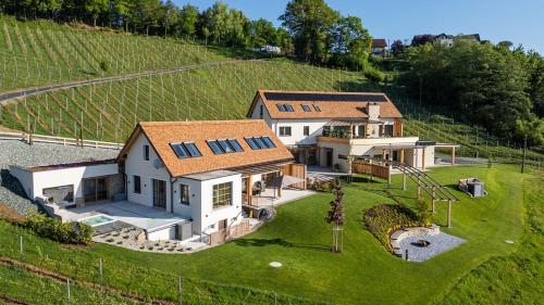 an aerial view of a house on a hill at steiRerBLiCke - Domaine Sernau Muscat in Gamlitz