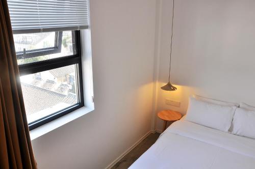 Ένα ή περισσότερα κρεβάτια σε δωμάτιο στο Xingle Hotel-Suzhou Guanqian Street Pingjiang Road