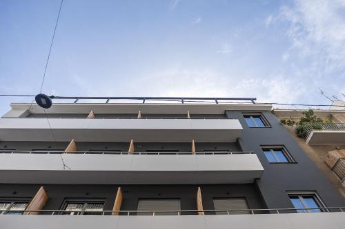 a gray building with a sky in the background at The Omnia Collection Pagrati in Athens