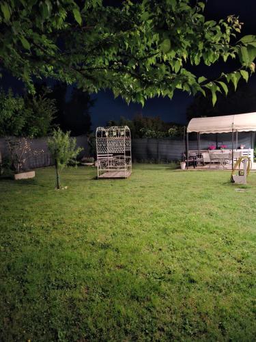 a backyard with a swing set and a tent at Armonie di Campagna Rooms & Breakfast di Valentini Sabina in Calderara di Reno
