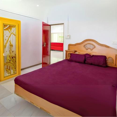 a bedroom with a large bed with purple sheets at Shiv Farm Where Nature Meets Luxury in Jalālpur